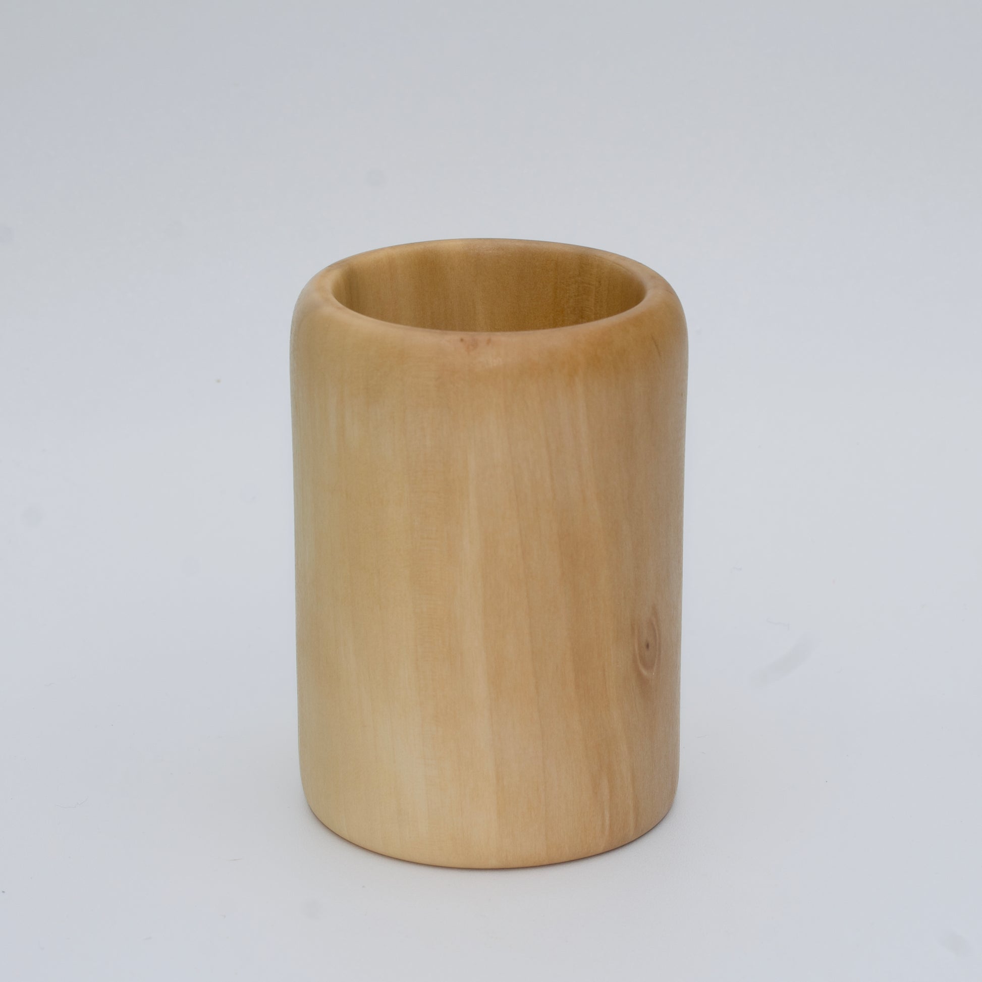 Sweetgum wood shot glass against white background