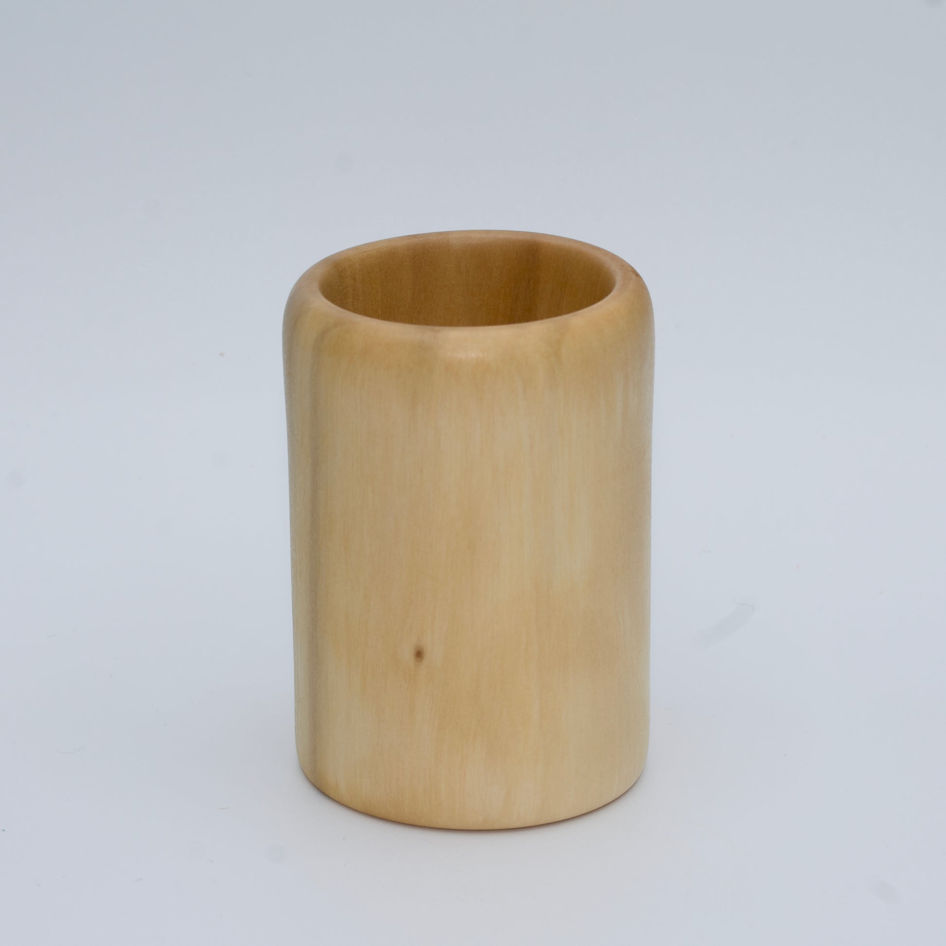 Sweetgum wood shot glass against white background