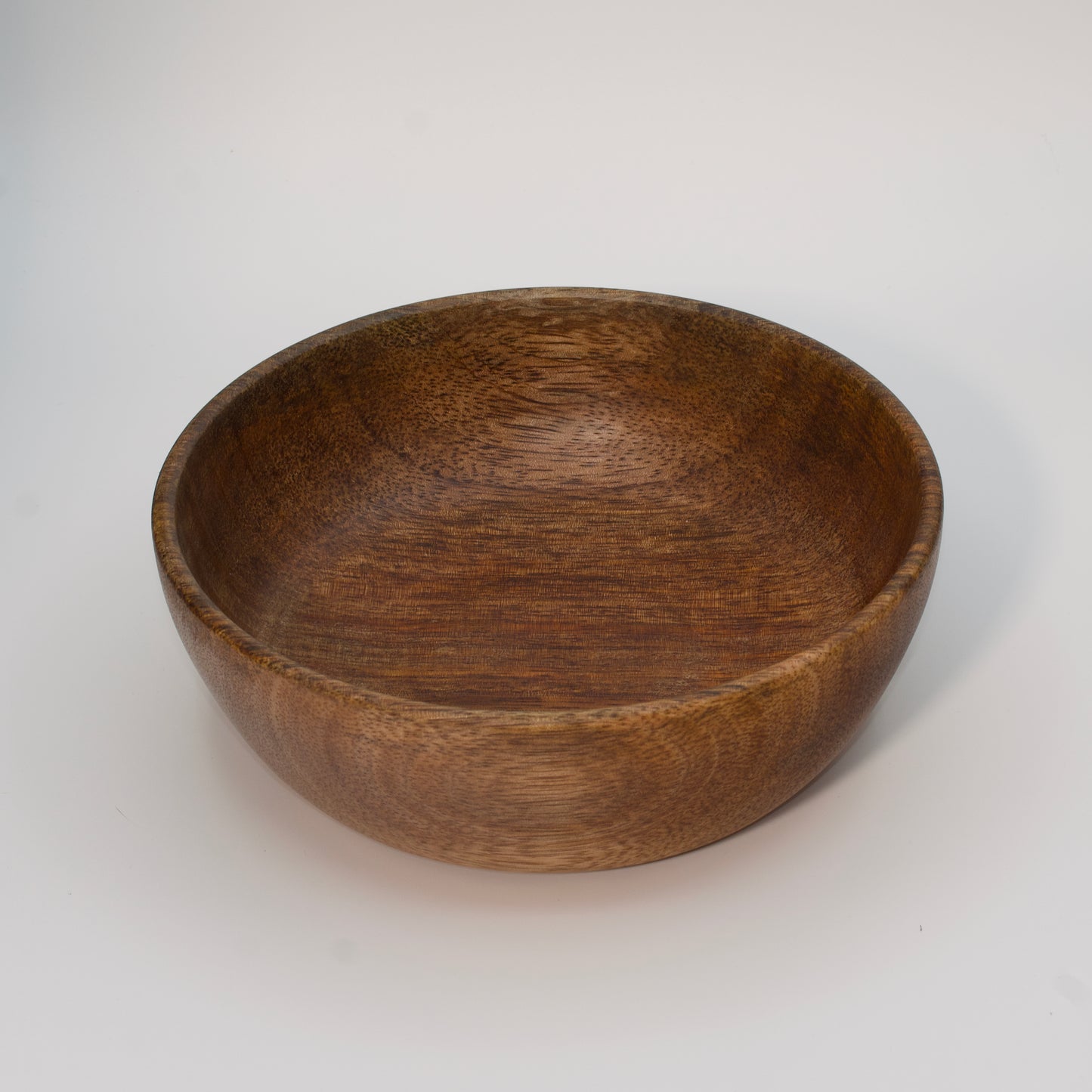 Mango wood bowl against white background