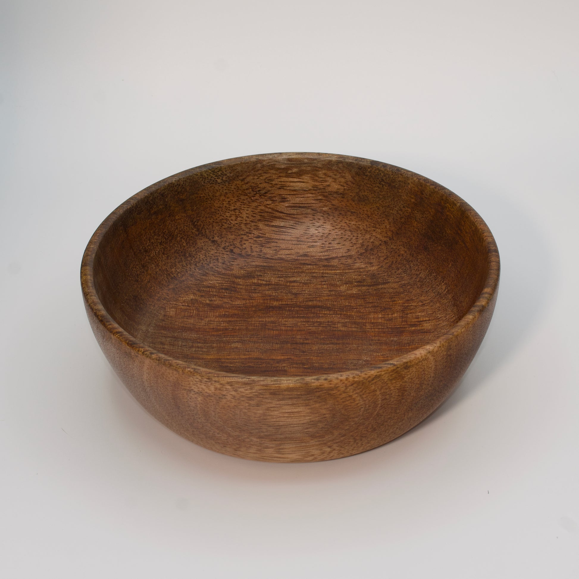 Mango wood bowl against white background