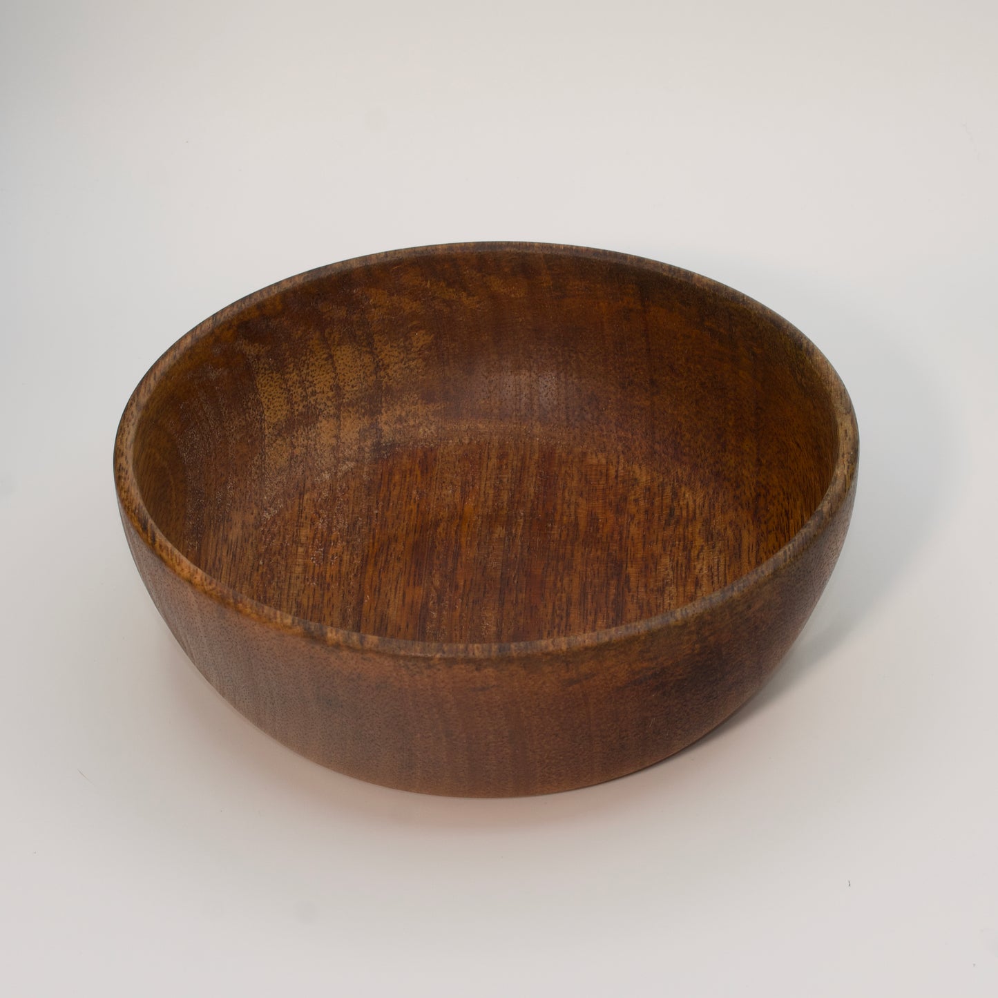 Mango wood bowl against white background