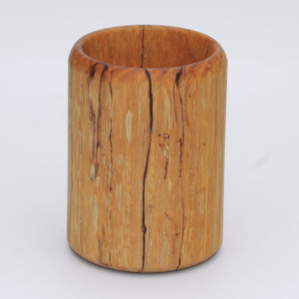 yellow wooden cup with back and white markings like a banana slug