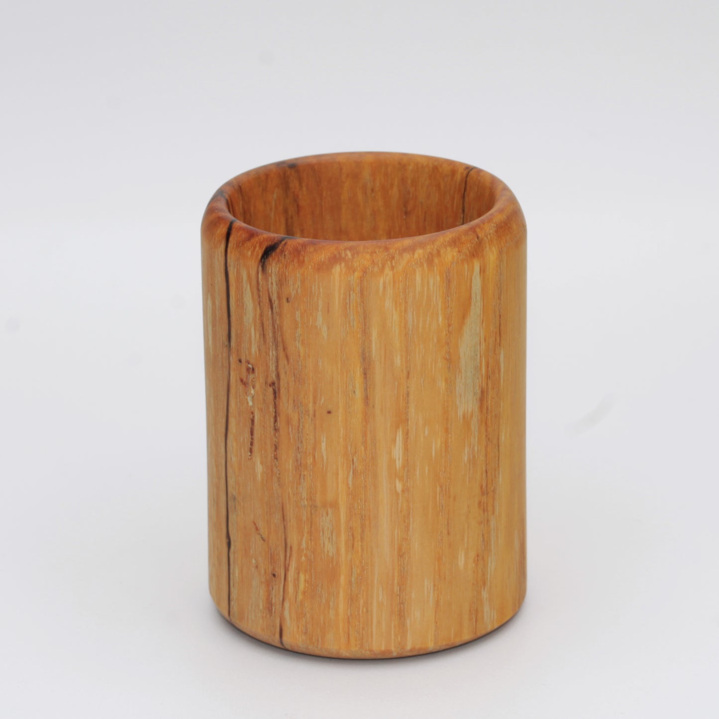 yellow wooden cup with back and white markings like a banana slug