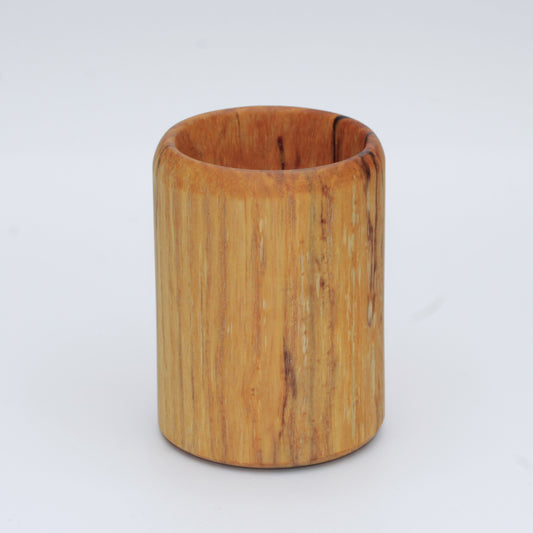 yellow wooden cup with back and white markings like a banana slug
