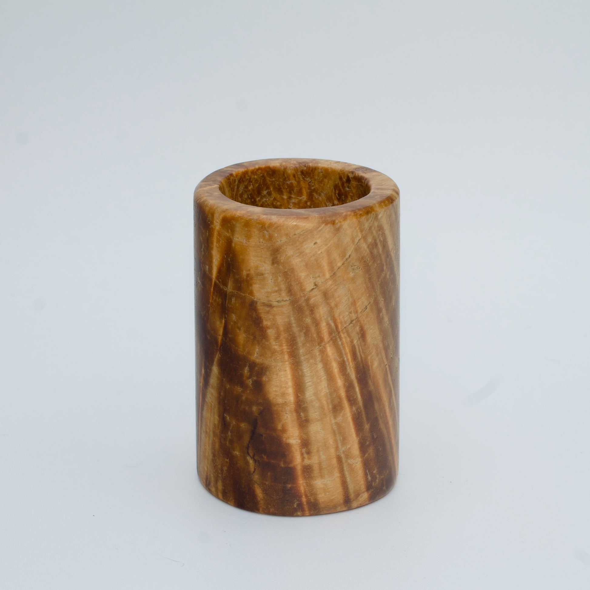 Box elder burl wood shot glass against white background