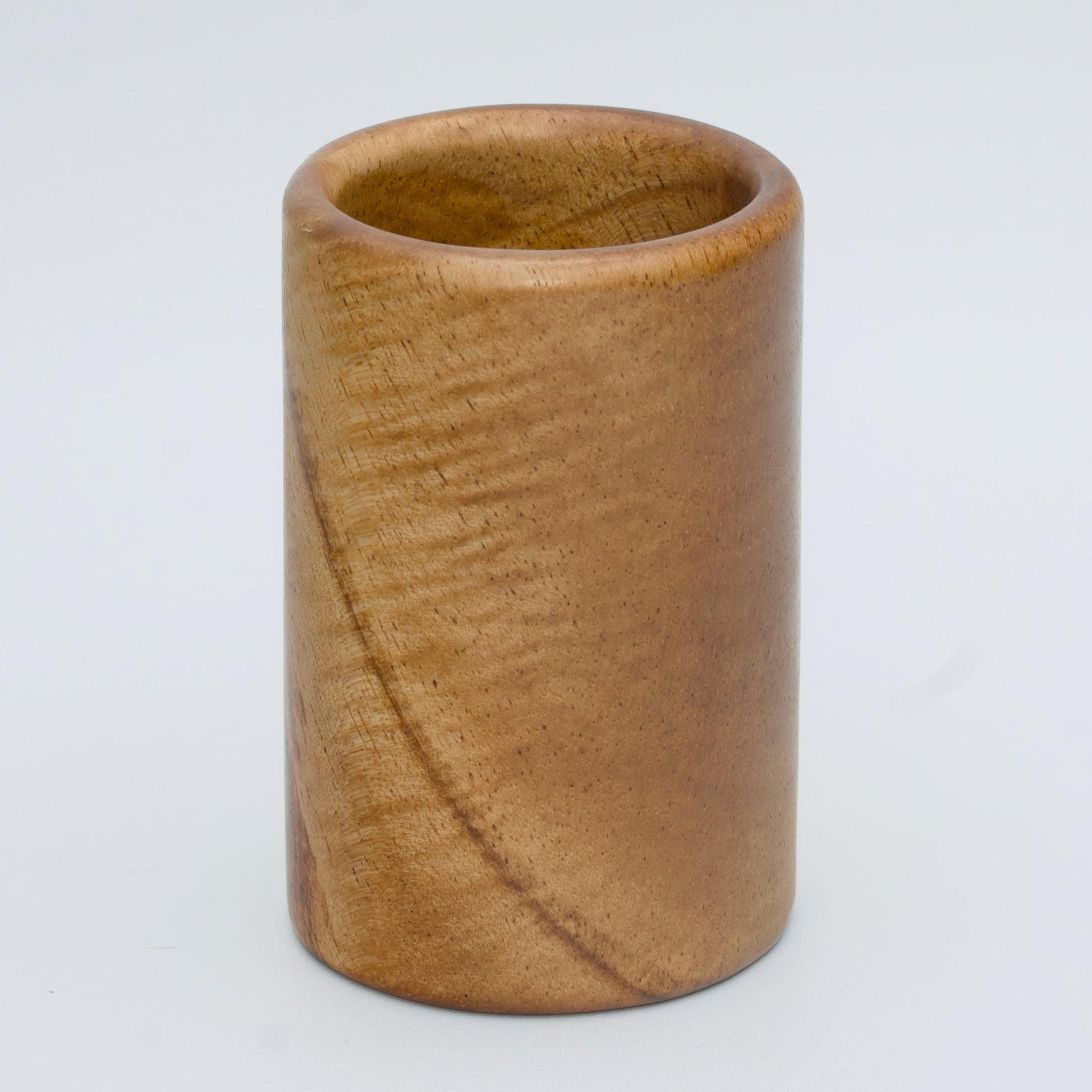 Acacia wood shot glass against white background