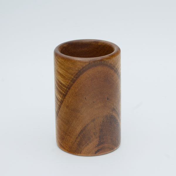 Acacia wood shot glass against white background