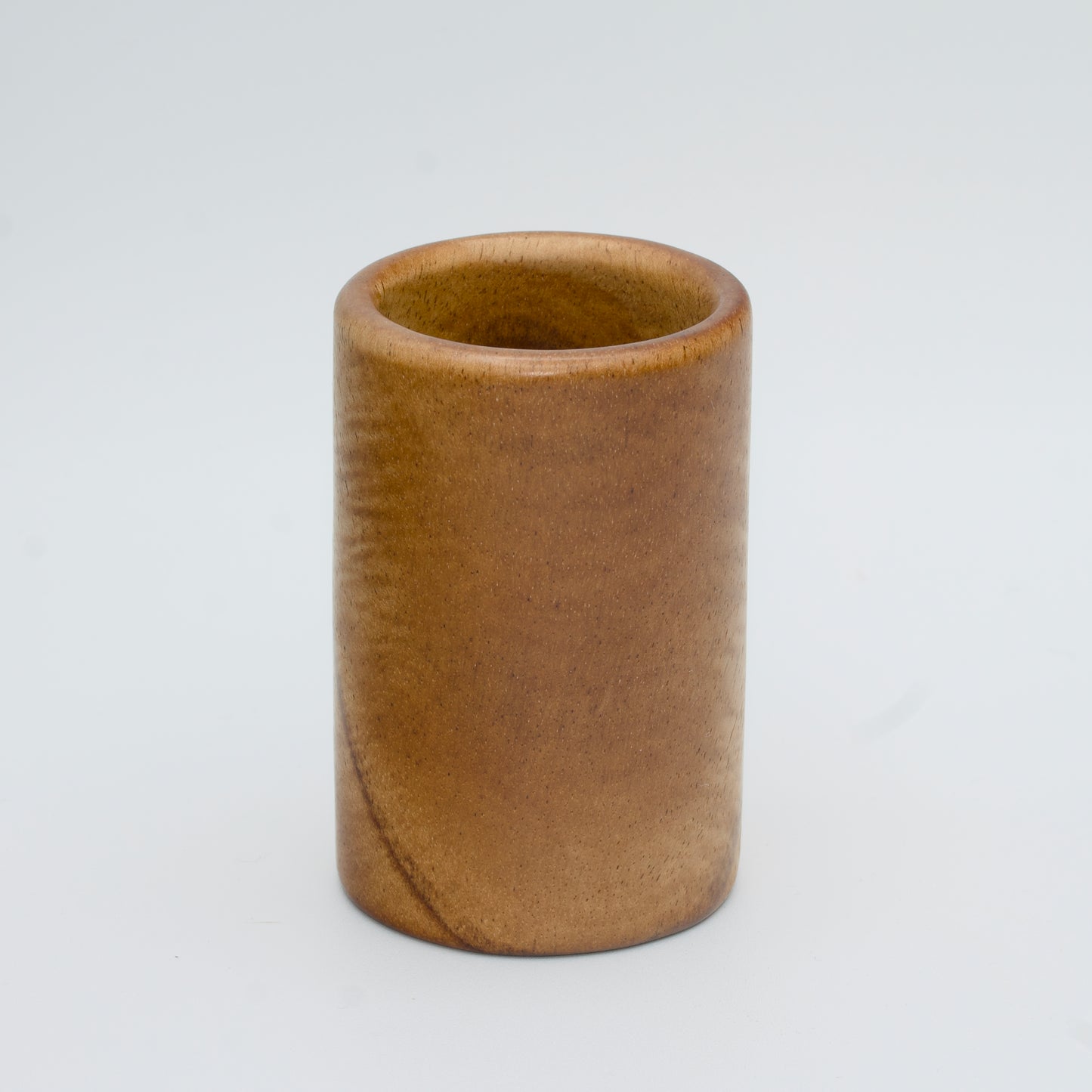 Acacia wood shot glass against white background