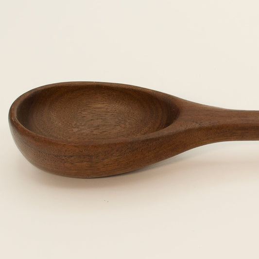 Wooden spoon on a beige background