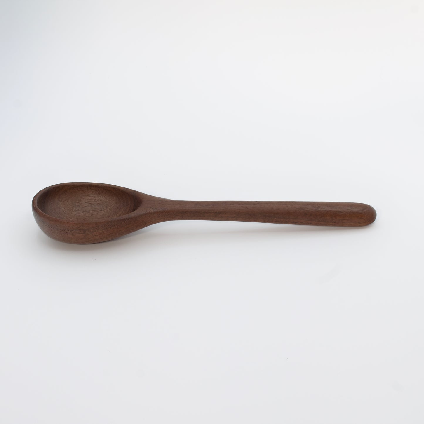 Wooden spoon on a beige background