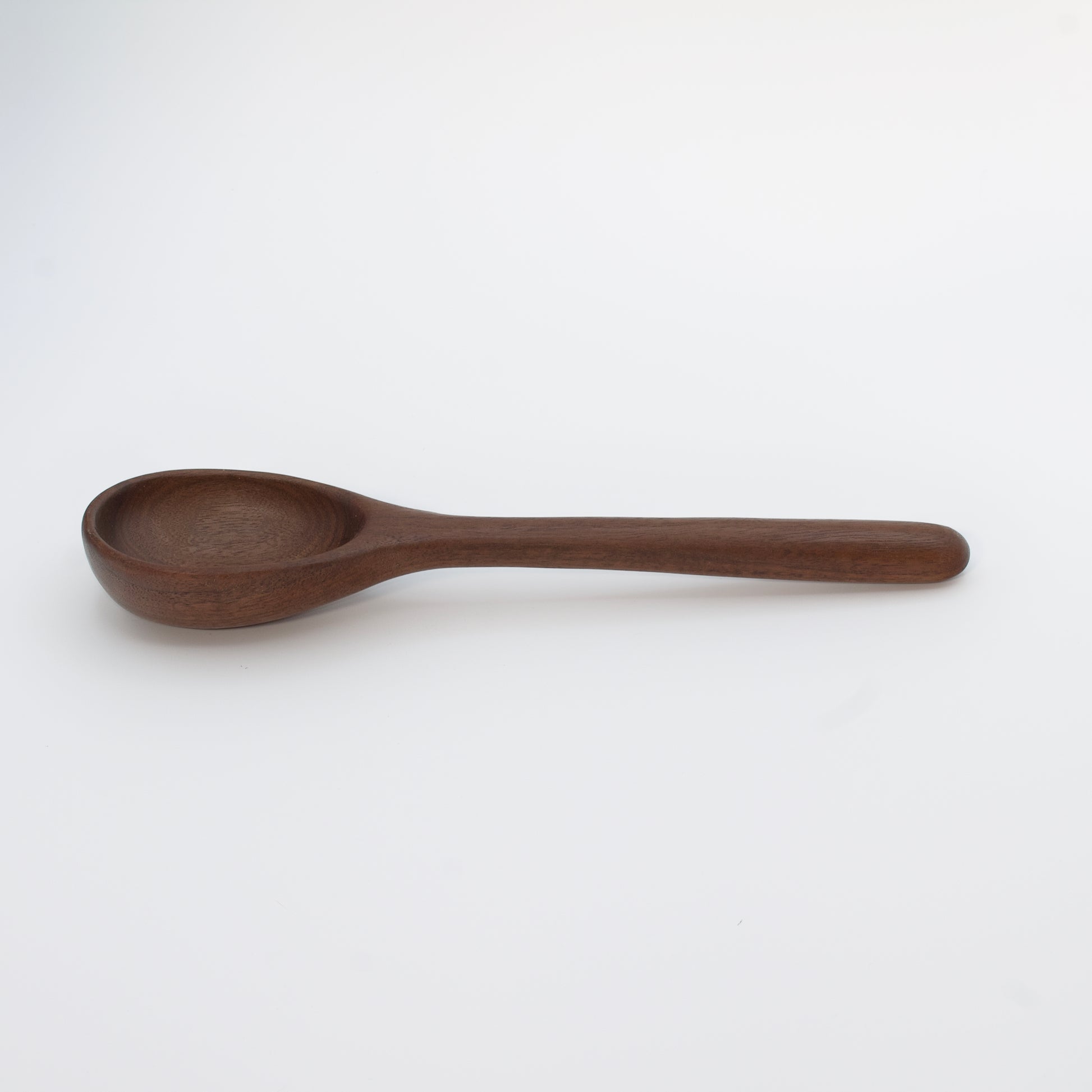 Wooden spoon on a beige background