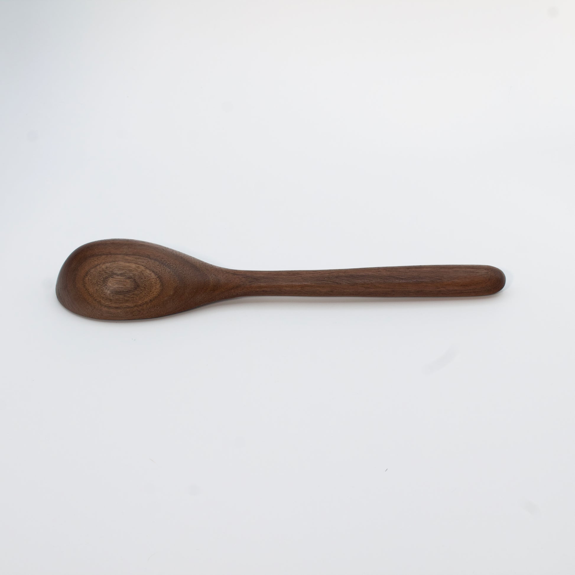 Wooden spoon on a beige background