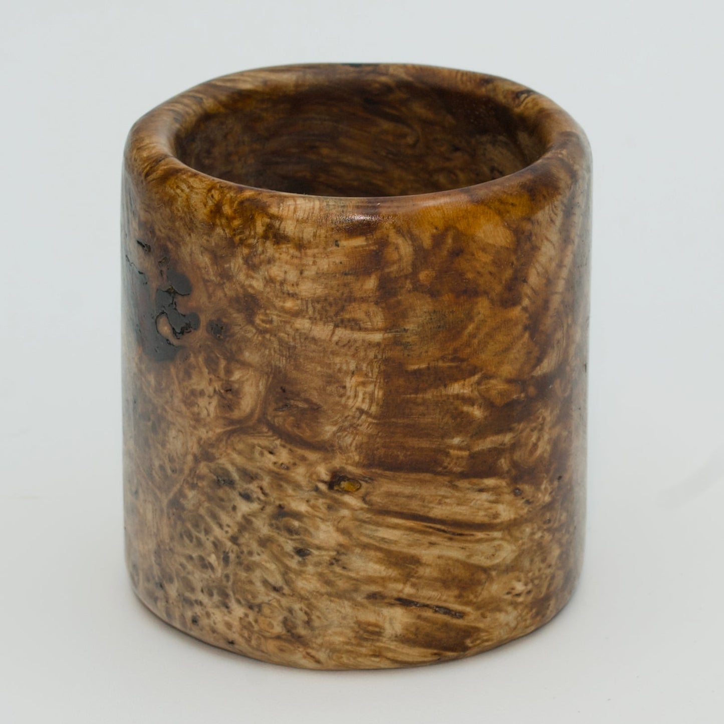 Amboyna burl wood shot glass on white background