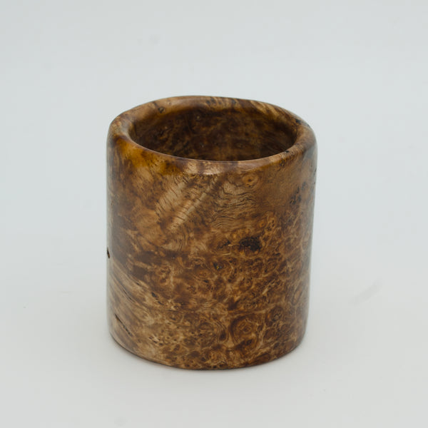 Amboyna burl wood shot glass on white background
