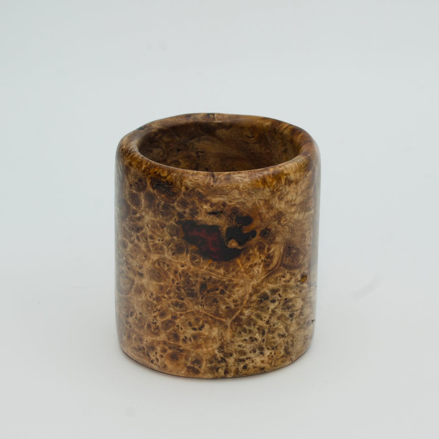 Amboyna burl wood shot glass on white background