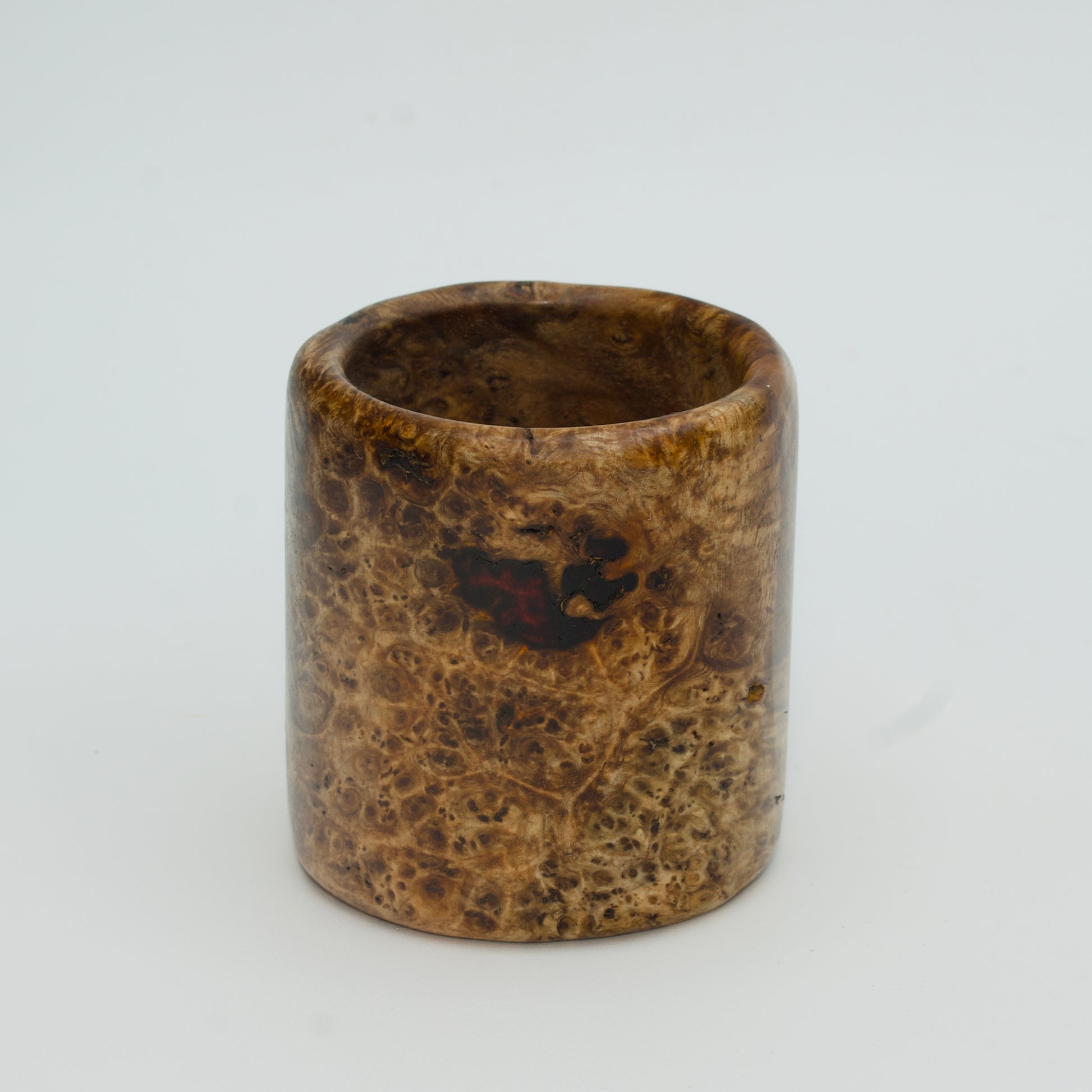 Amboyna burl wood shot glass on white background