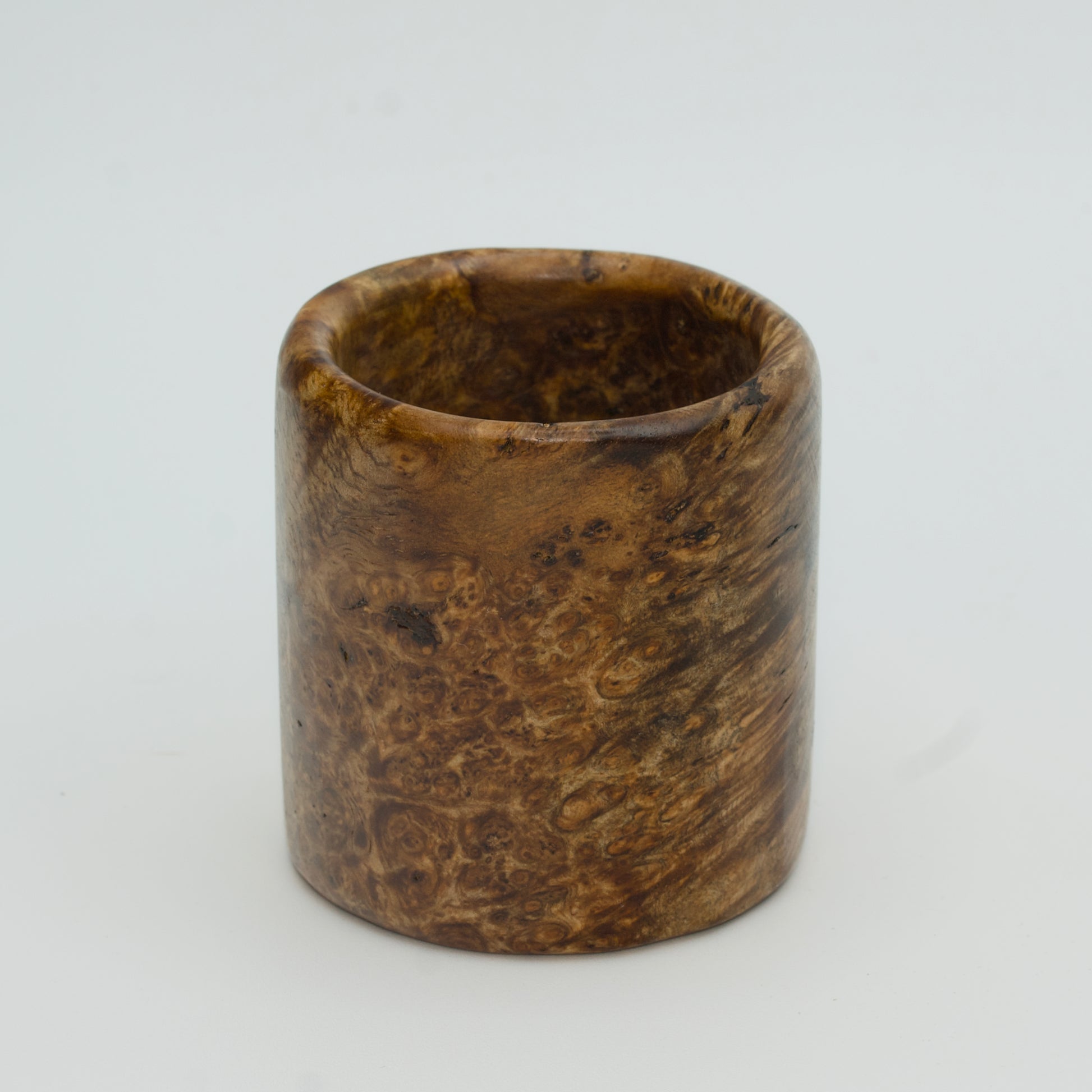 Amboyna burl wood shot glass on white background
