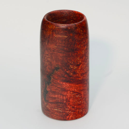 Red amboyna burl shot glass against white background