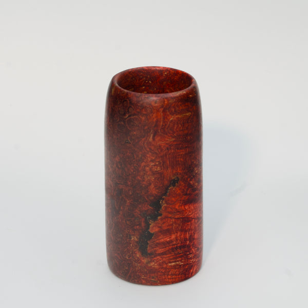 Red amboyna burl shot glass against white background