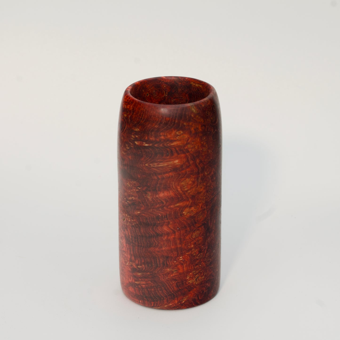 Red amboyna burl shot glass against white background