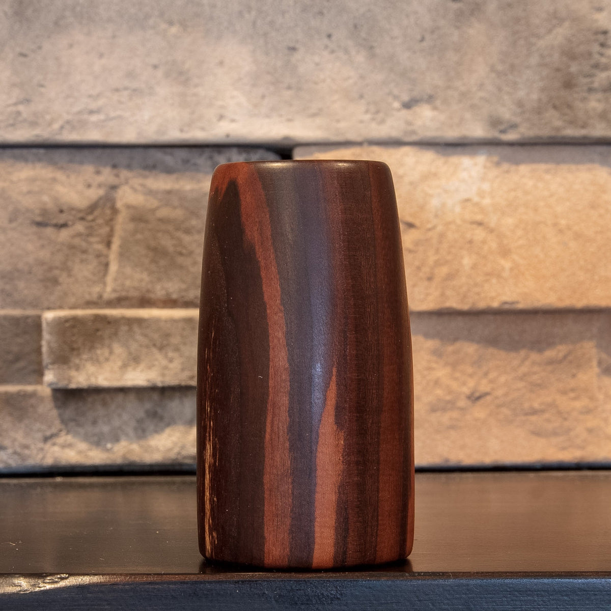 Eastern Redbud shot glass showing narrow red grain ribbons through dark heartwood