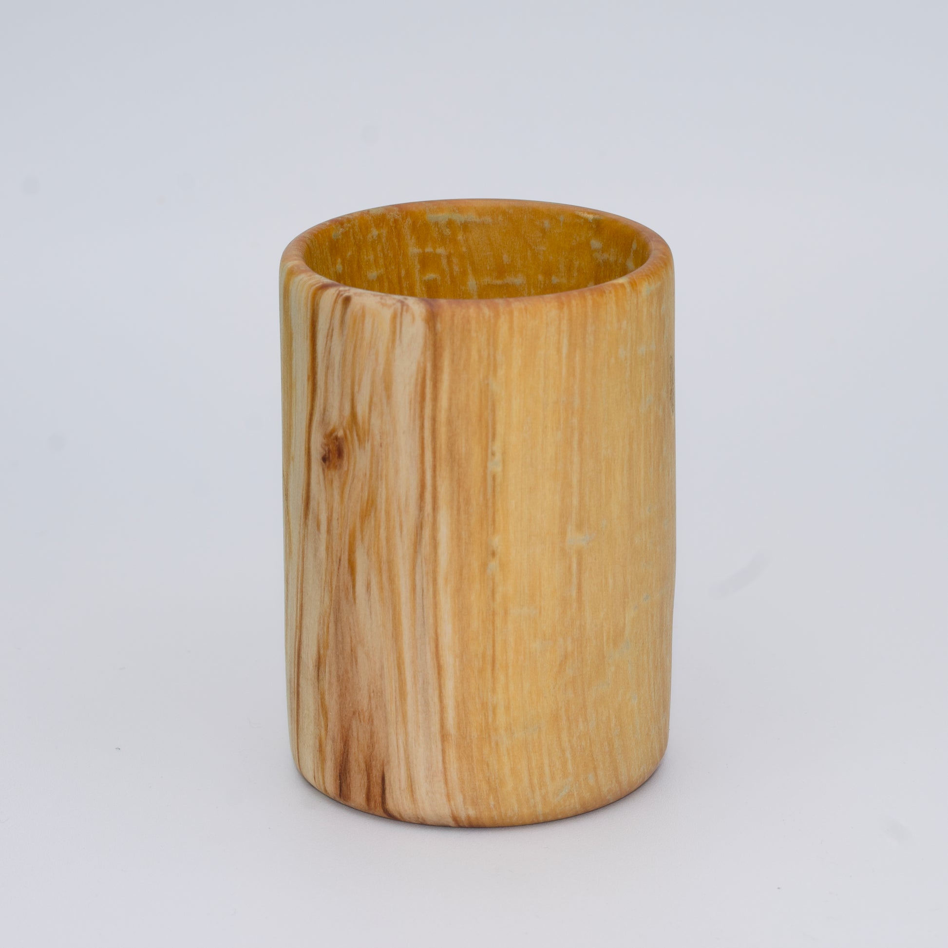 Aspen wood shot glass with gold dye against white background