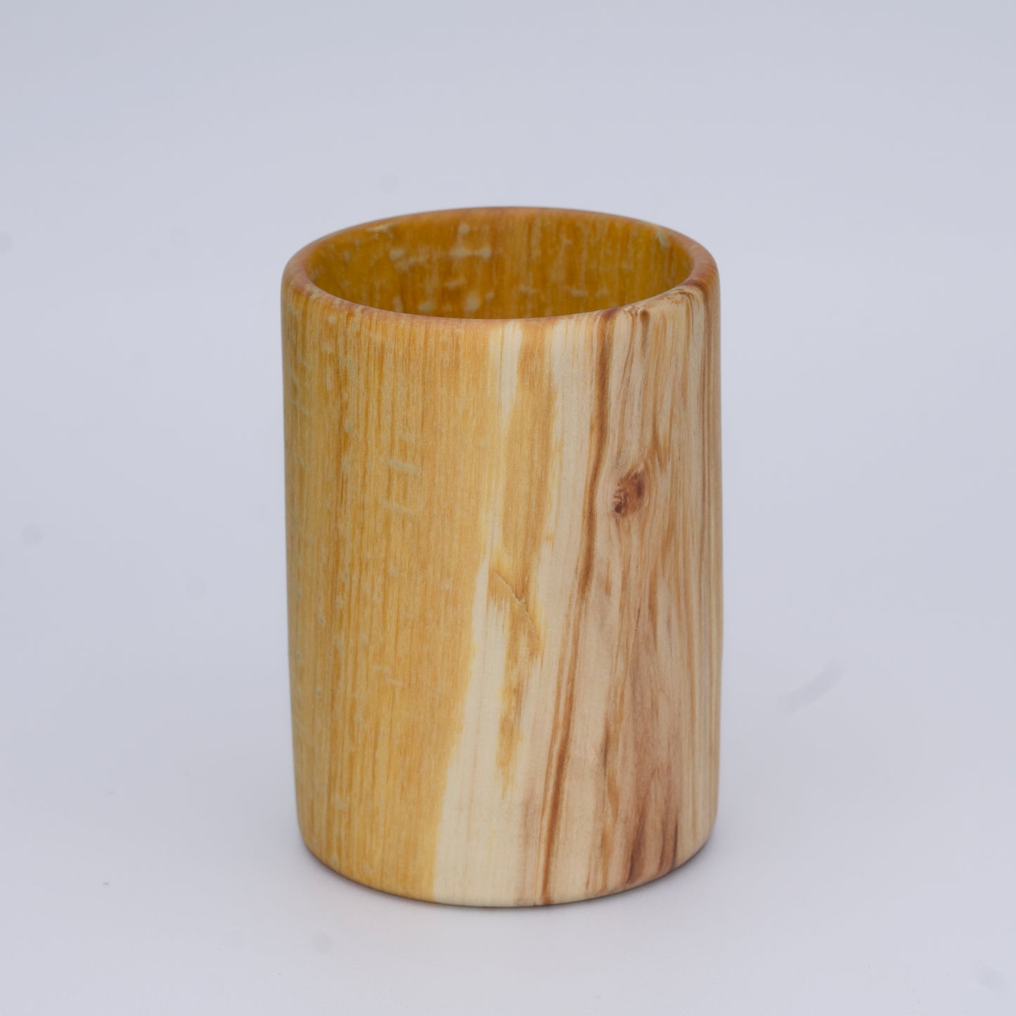 Aspen wood shot glass with gold dye against white background