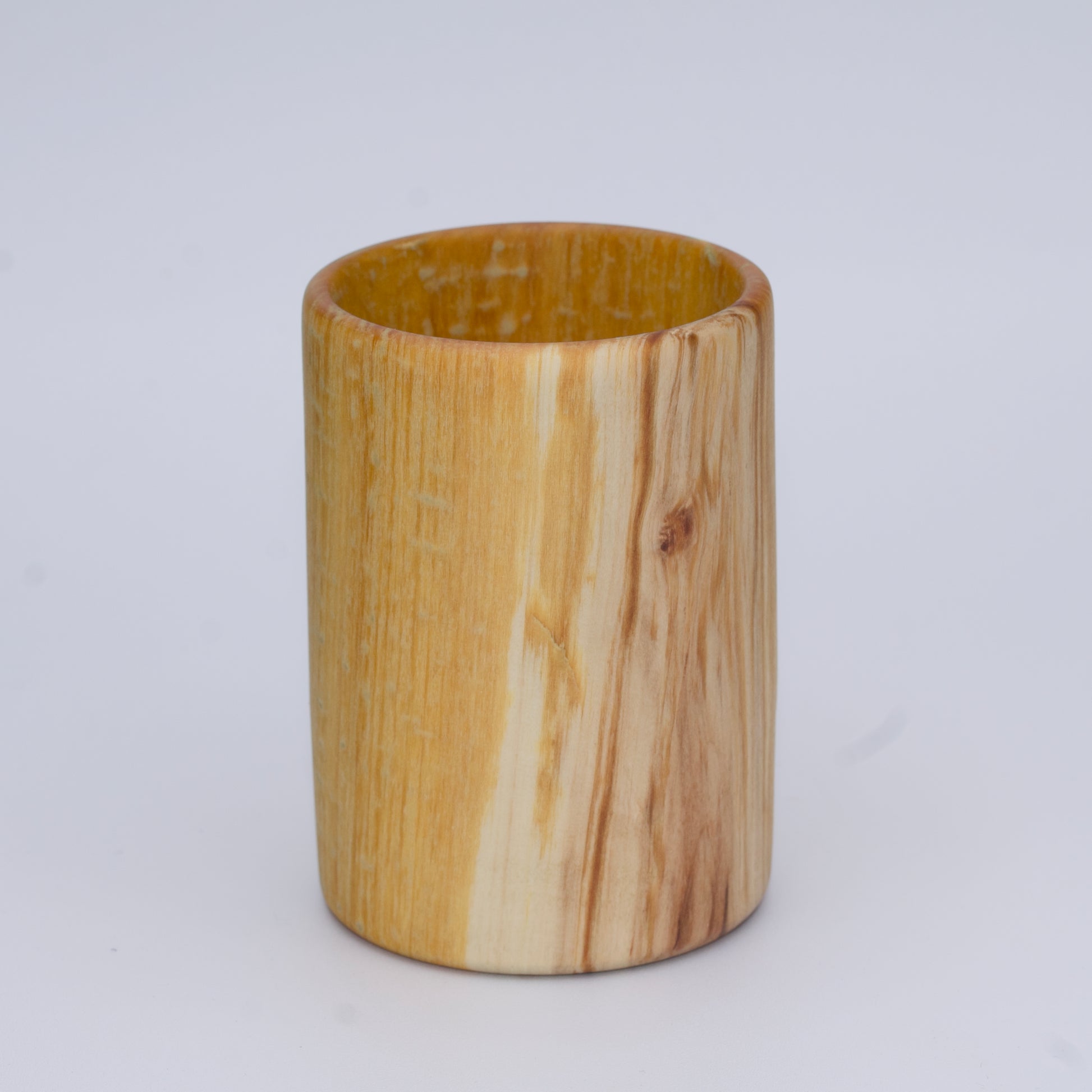 Aspen wood shot glass with gold dye against white background