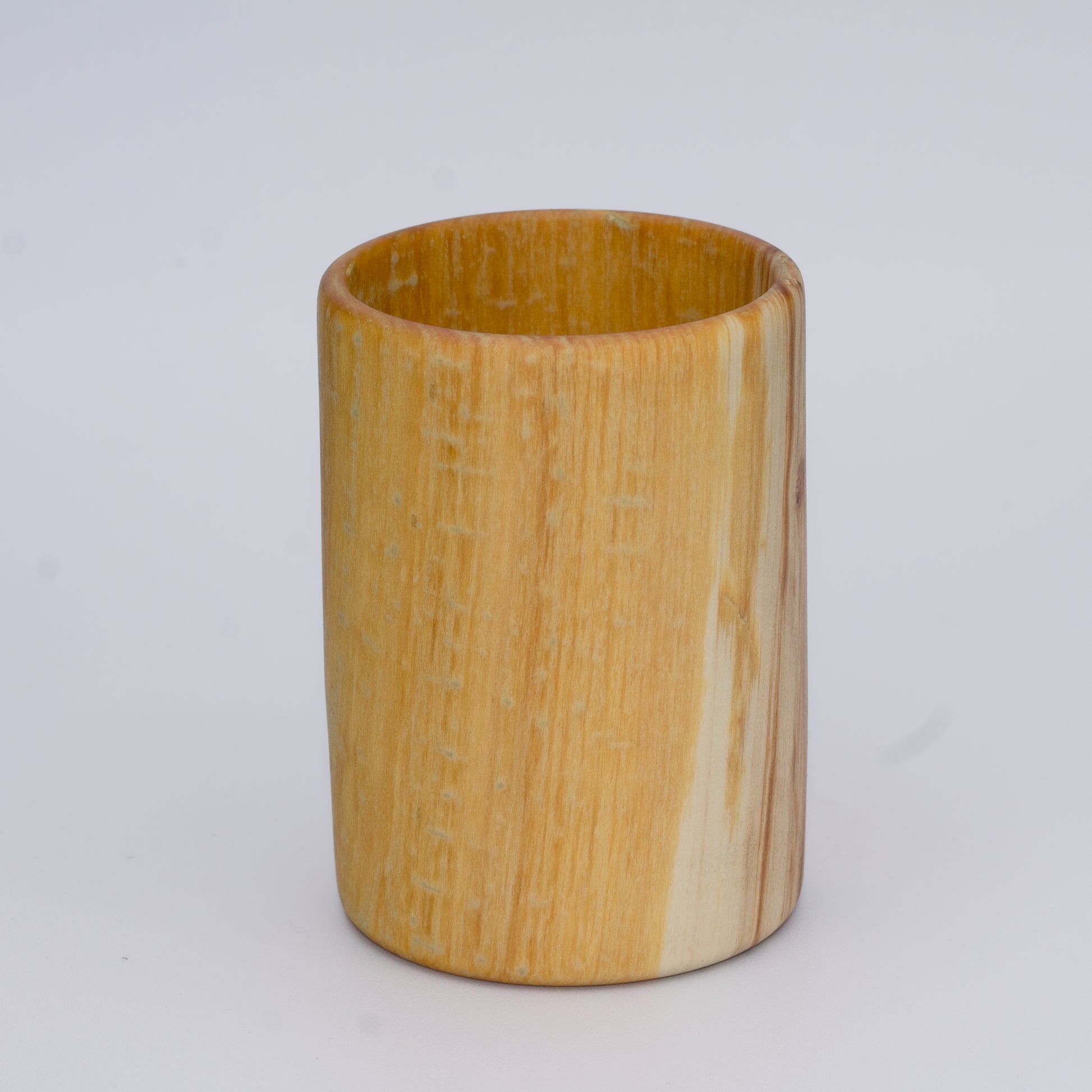 Aspen wood shot glass with gold dye against white background
