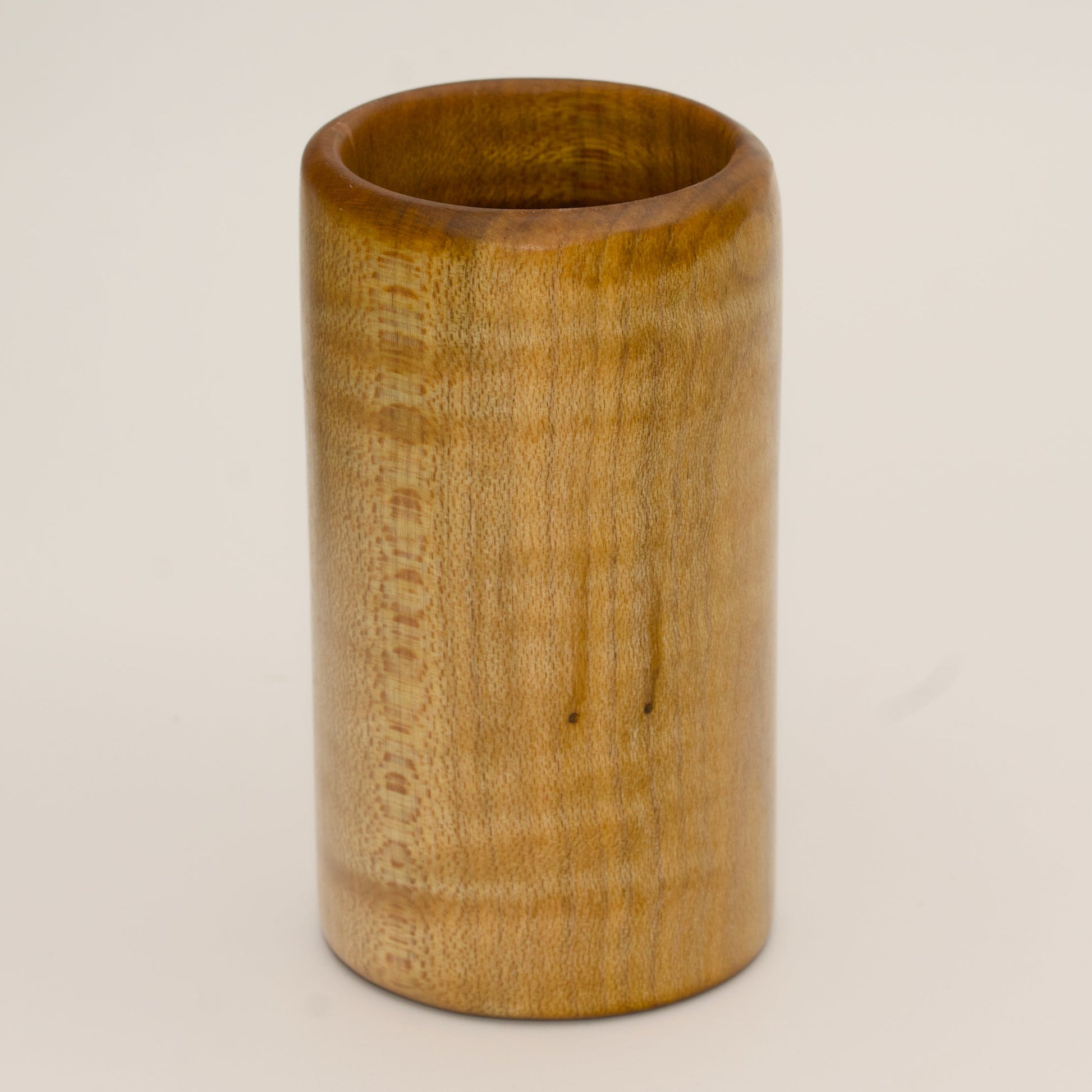 Maple burl shot glass on white background