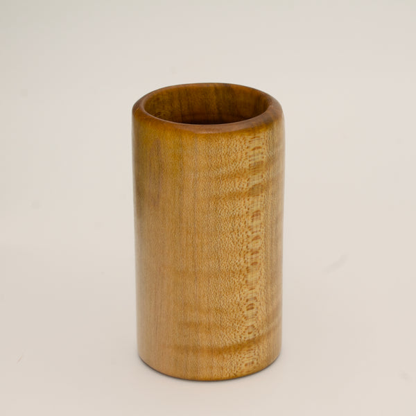 Maple burl shot glass on white background