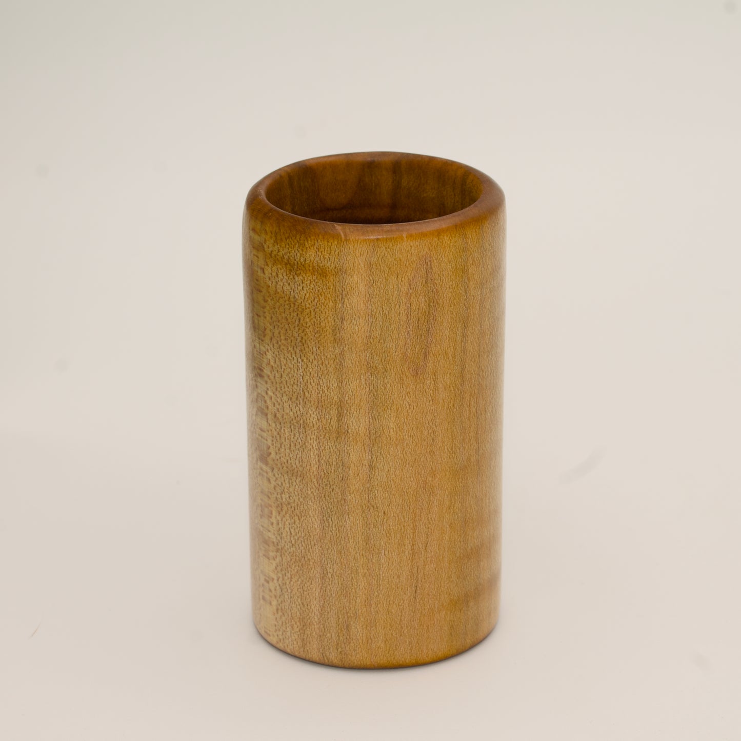 Maple burl shot glass on white background
