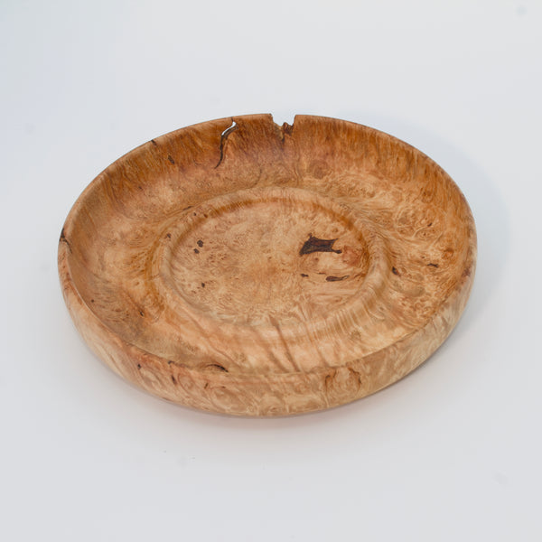 Decorative wooden plate from big leaf maple burl on a white background