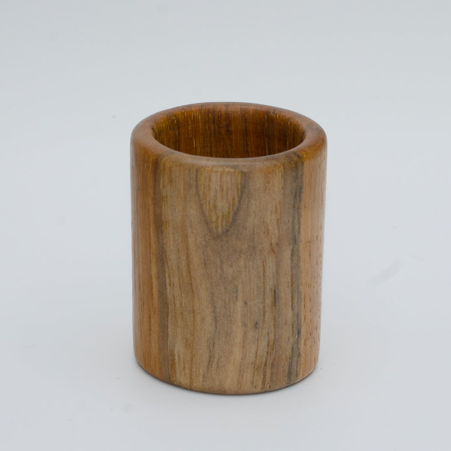 Pecan shot glass against white background