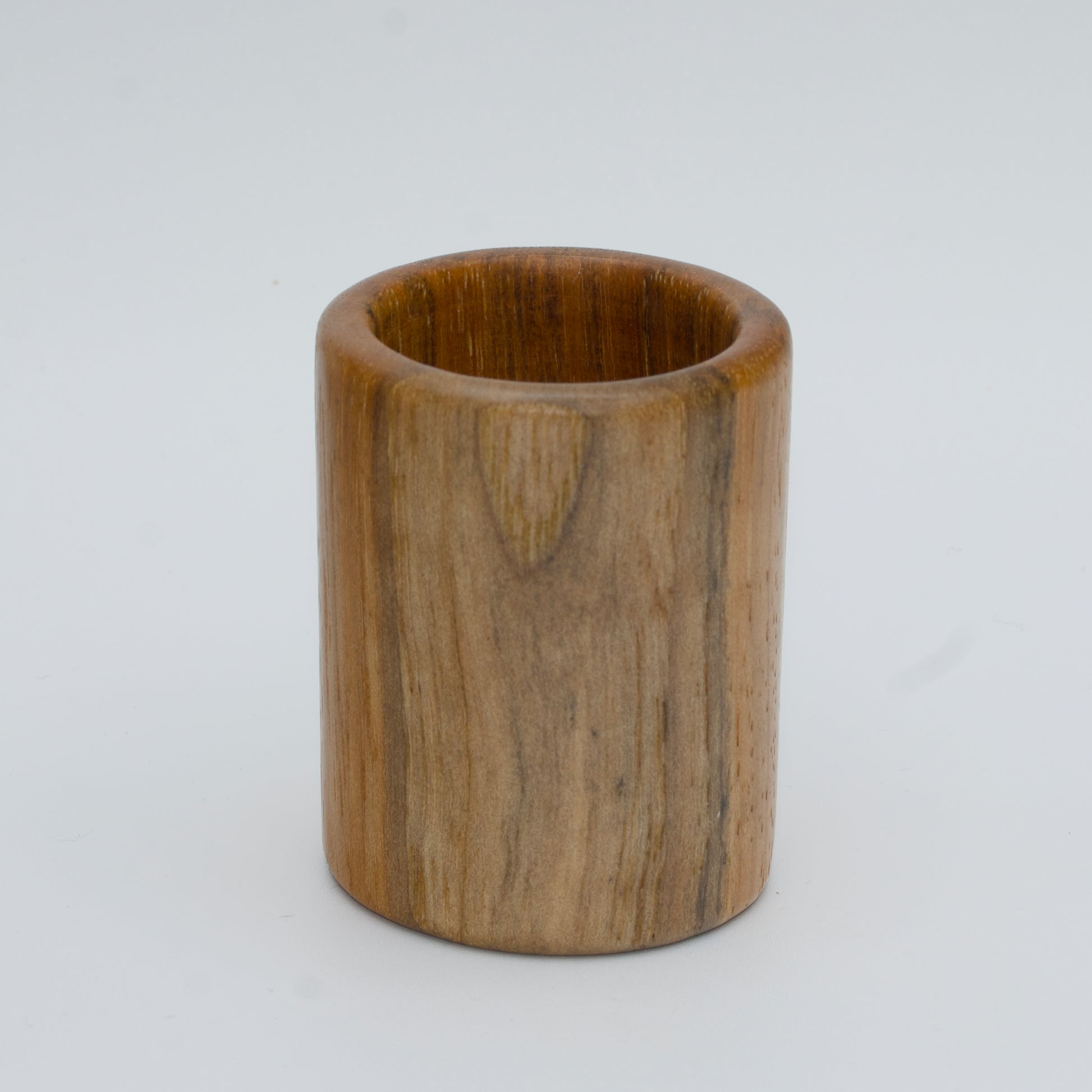 Pecan shot glass against white background