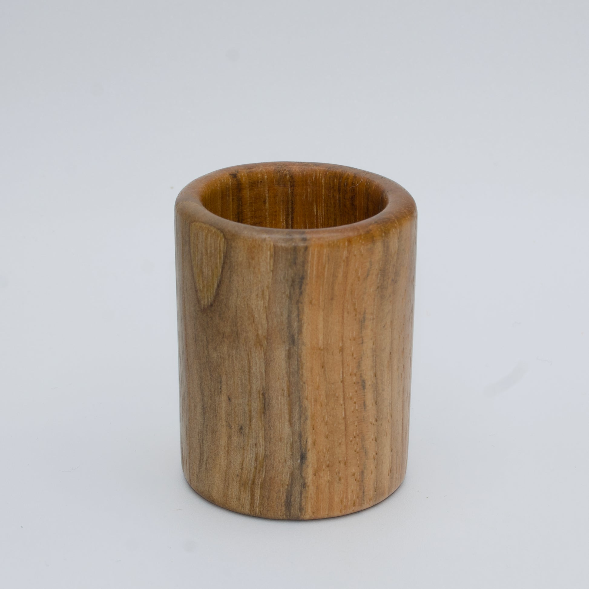 Pecan shot glass against white background