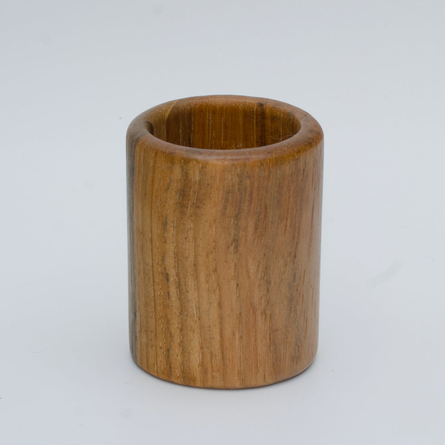 Pecan shot glass against white background
