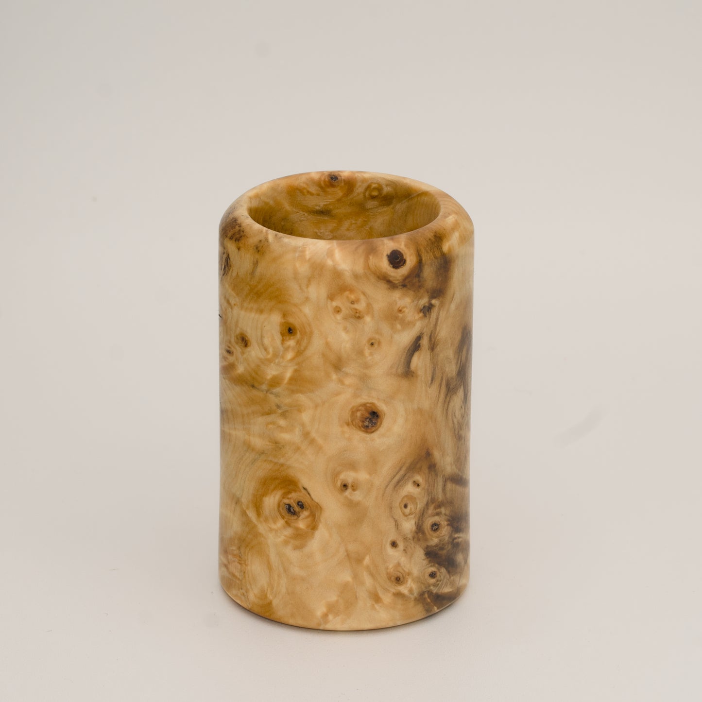 Buckeye burl wood shot glass against white background