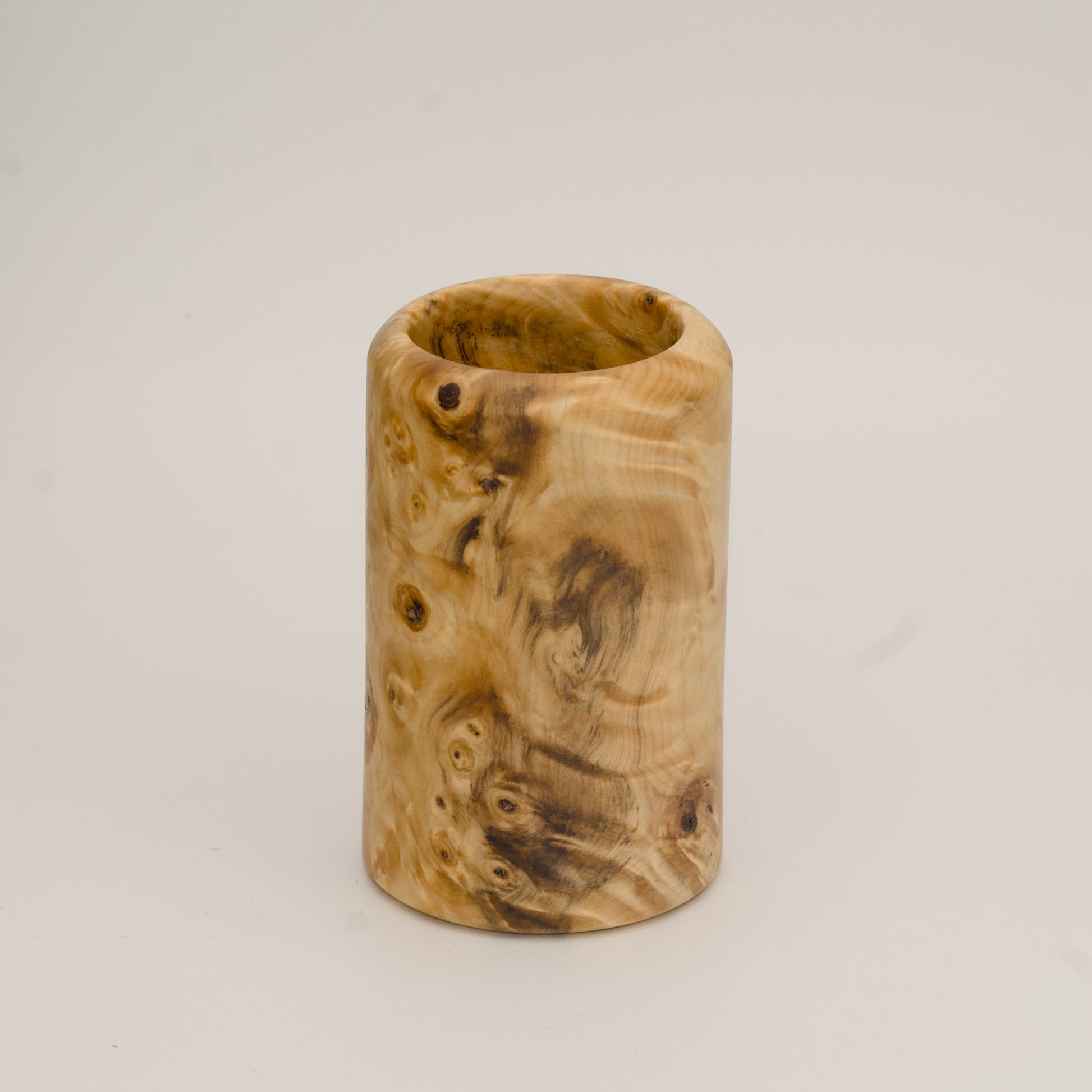 Buckeye burl wood shot glass against white background