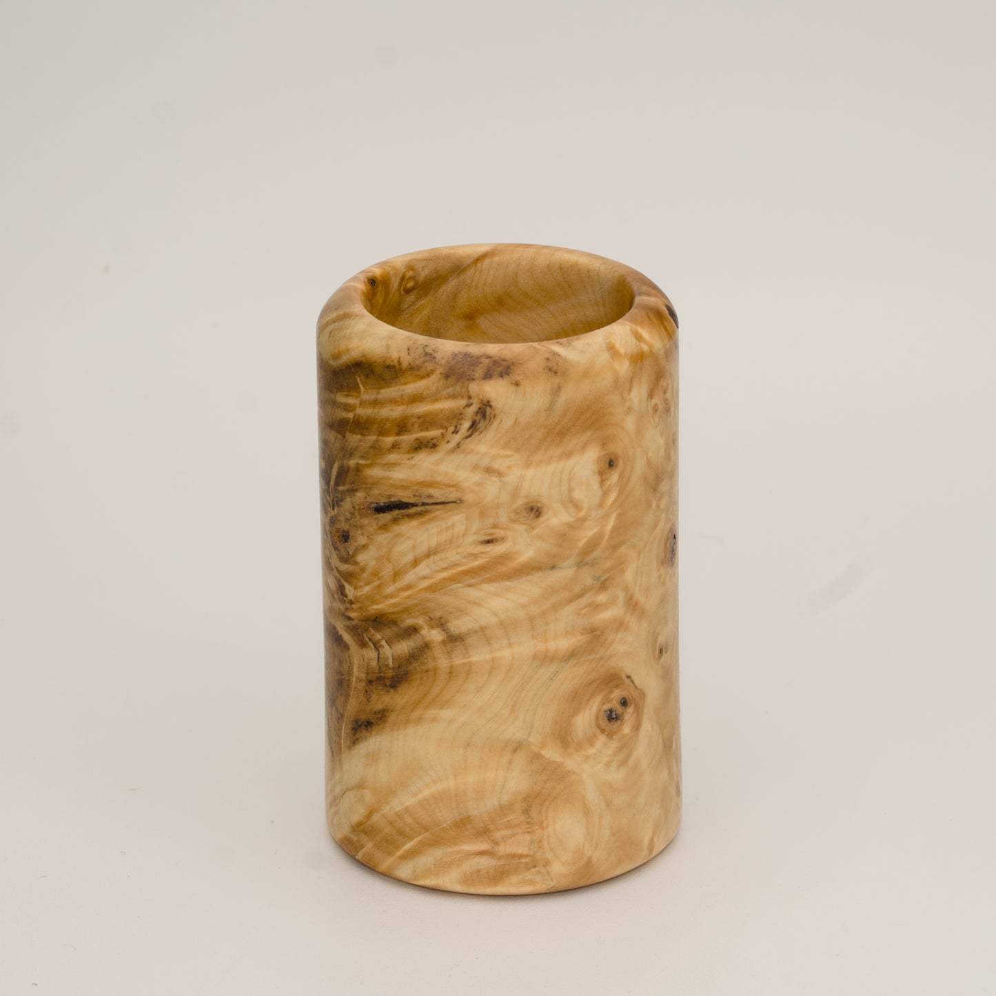 Buckeye burl wood shot glass against white background