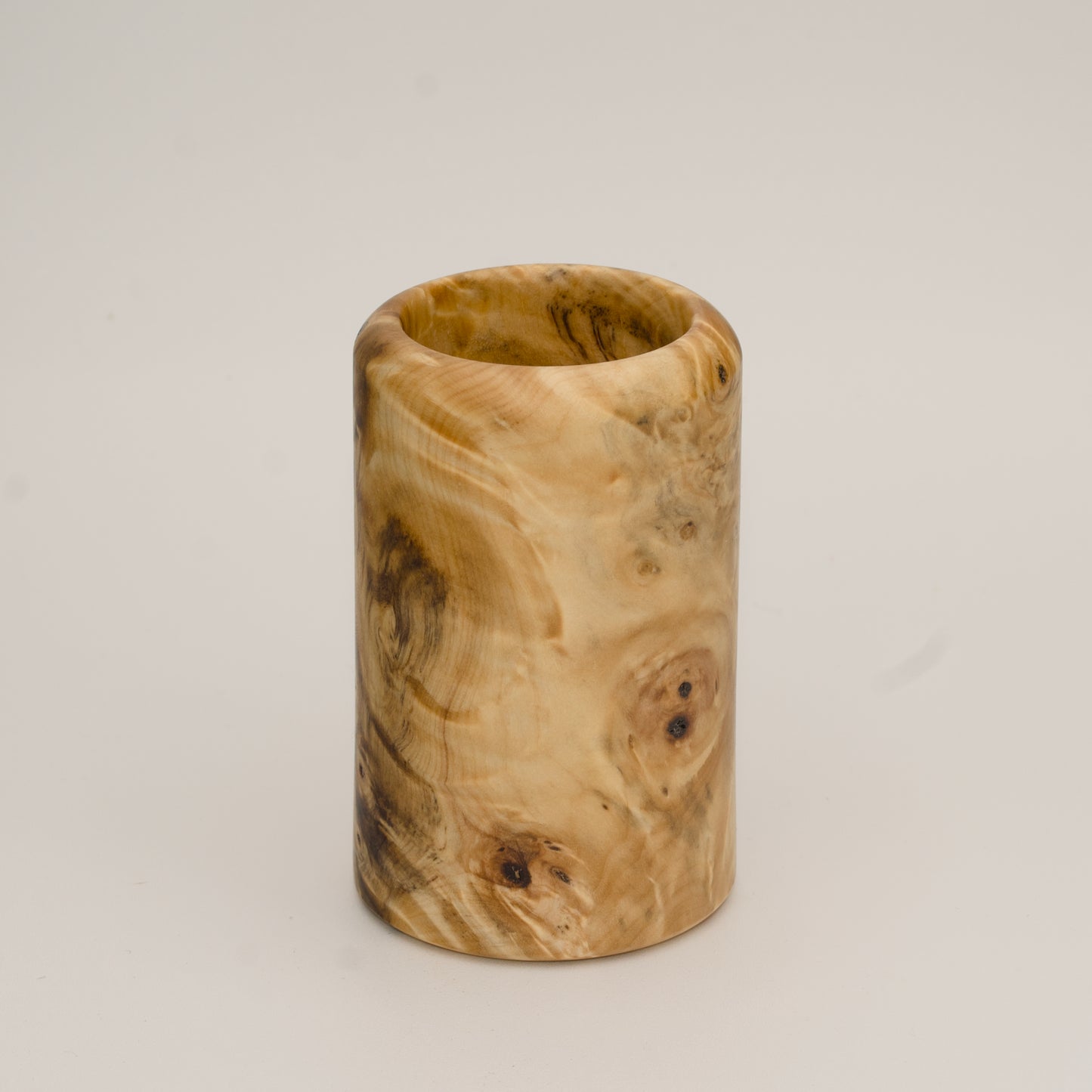 Buckeye burl wood shot glass against white background