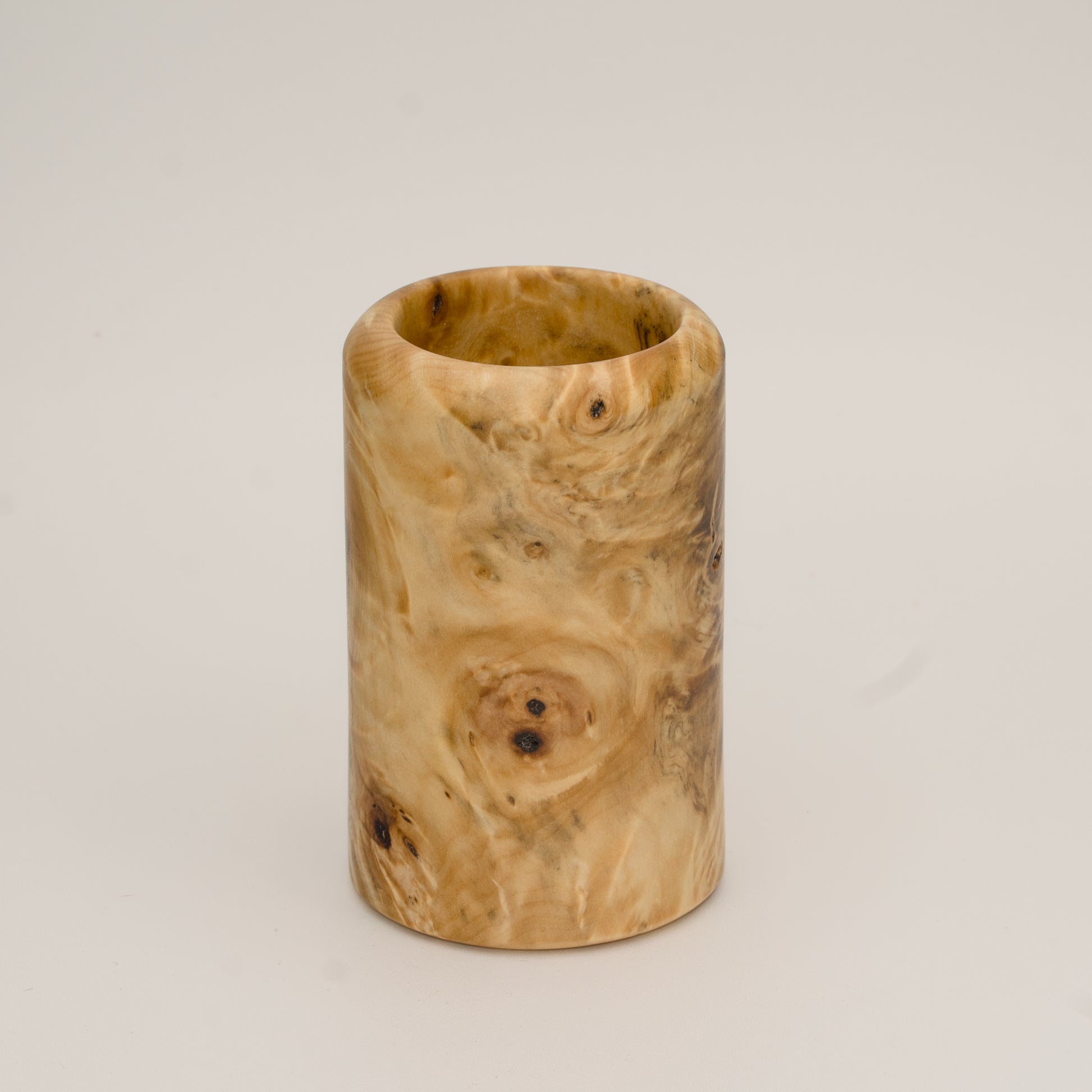 Buckeye burl wood shot glass against white background