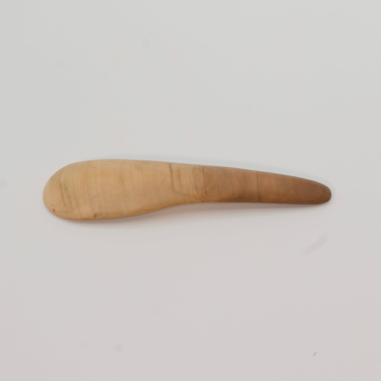 Wooden spoon on a light gray background