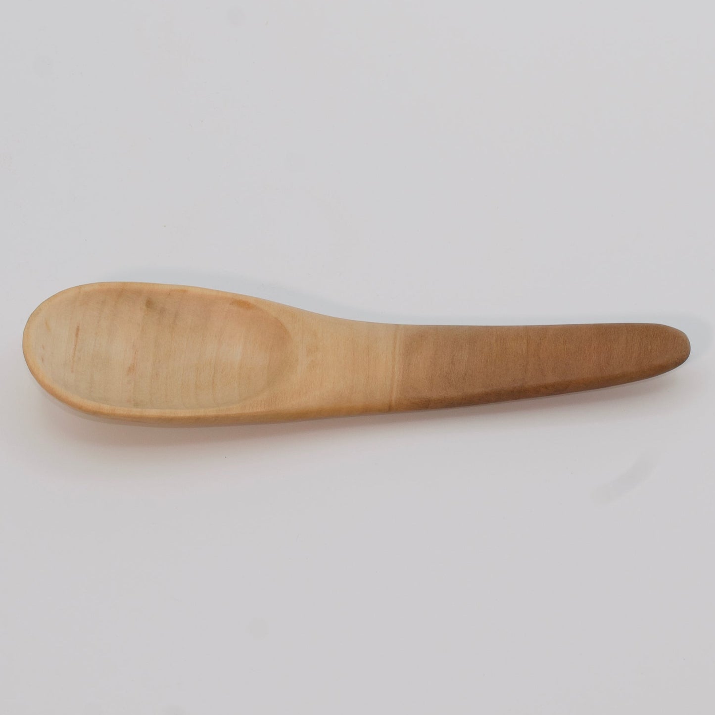 Wooden spoon on a light gray background