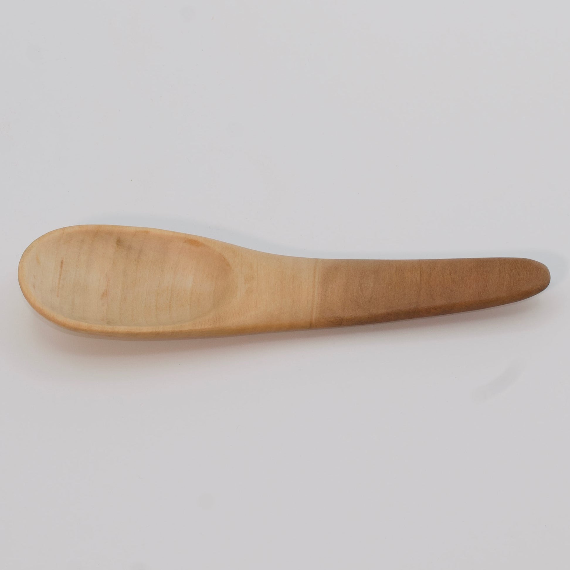 Wooden spoon on a light gray background