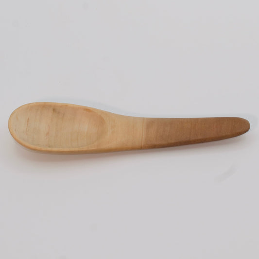Wooden spoon on a light gray background