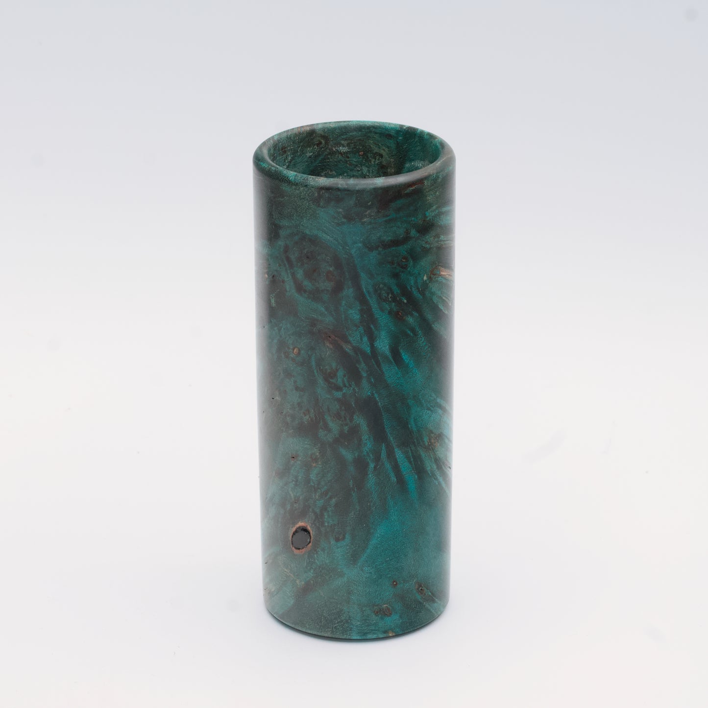 Teal Mapa Burl wood shot glass against white background