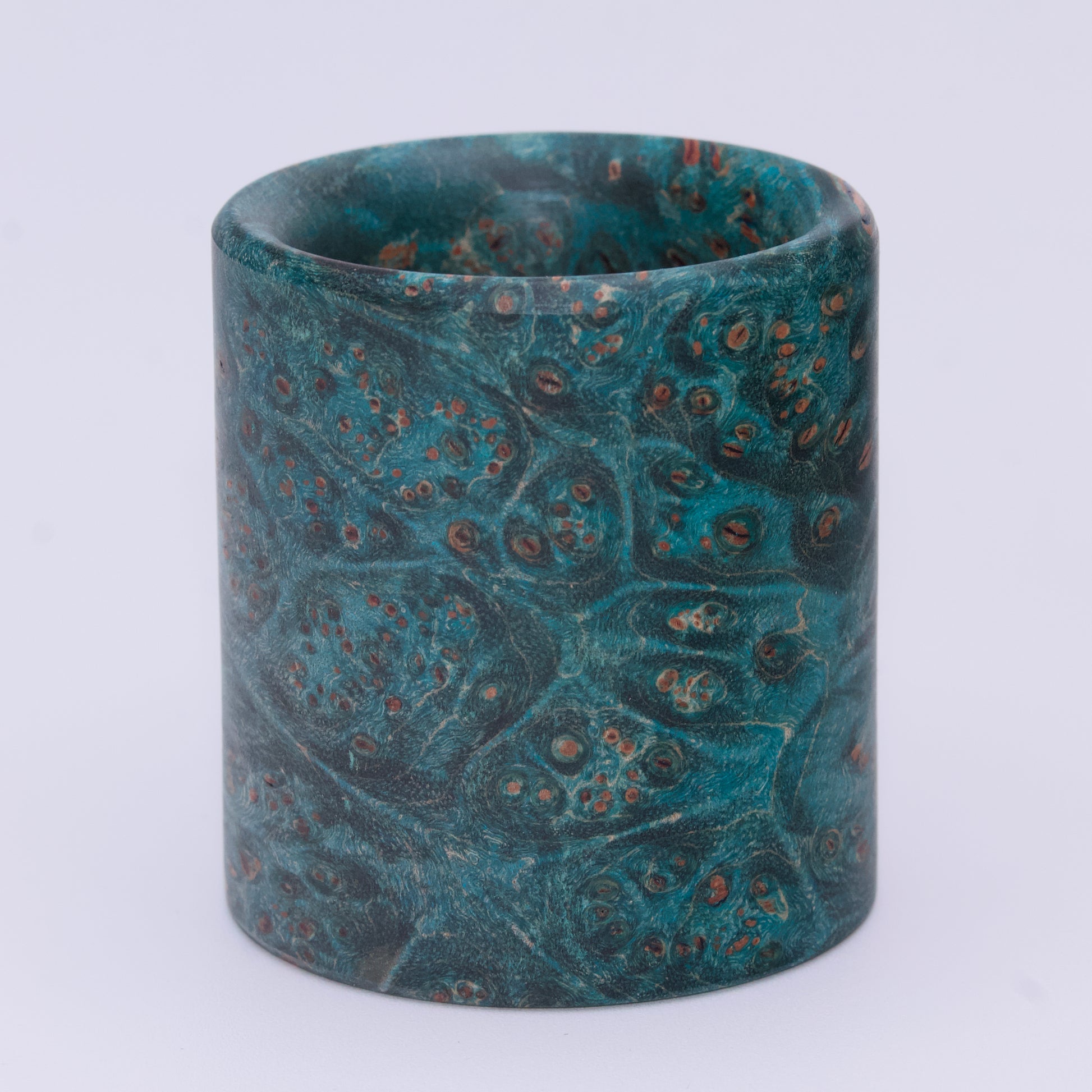 Blue  maple burl wood shot glass against white background