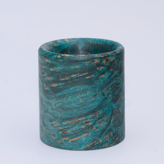Blue  maple burl wood shot glass against white background