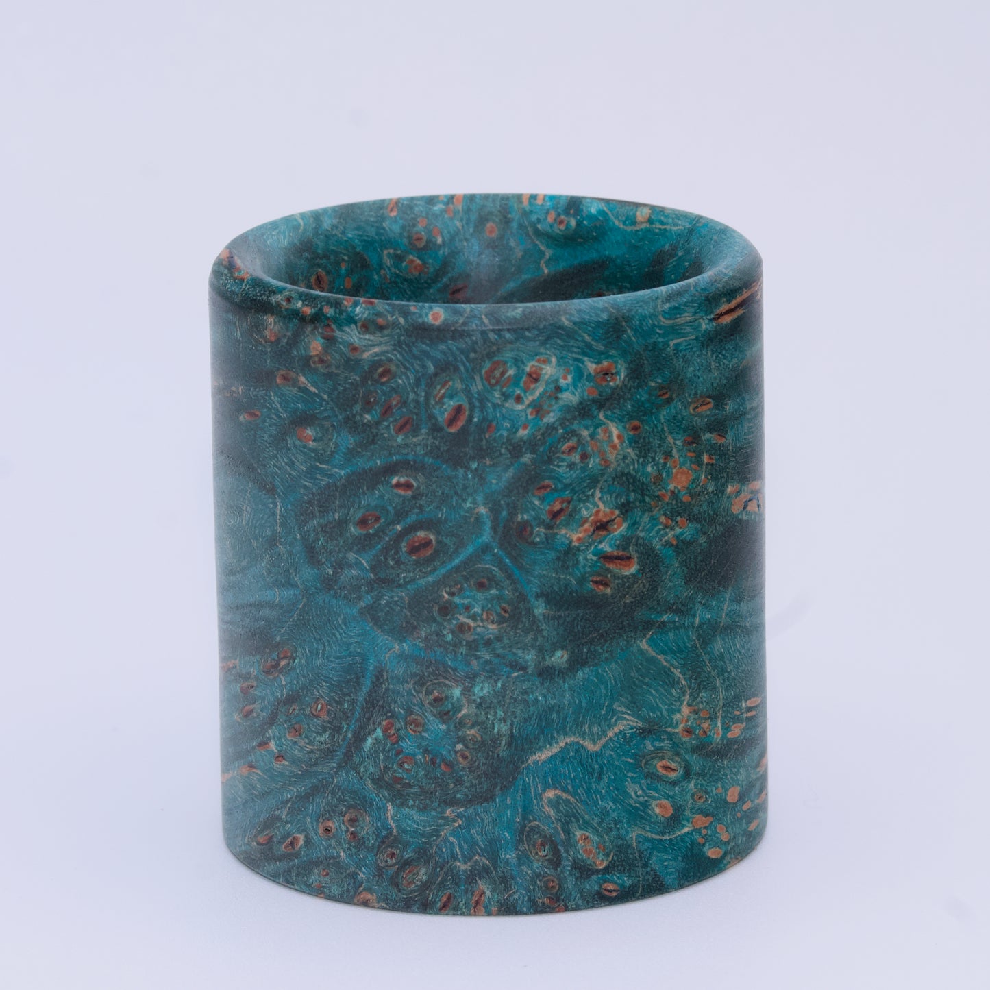 Blue  maple burl wood shot glass against white background